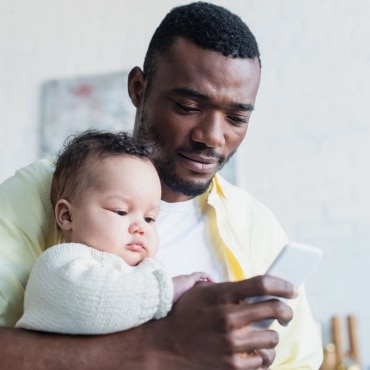 dad-holds-baby-dials-cell-phone